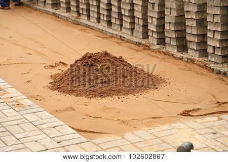induration sand and laying paving slabs