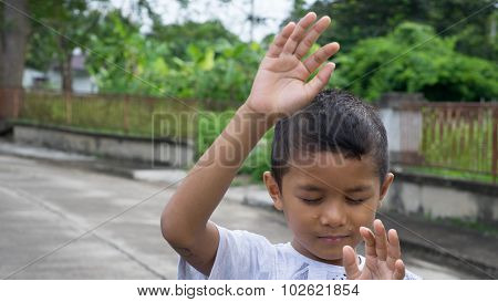 Young Asian boy using his hand to protect himself from physical abuse