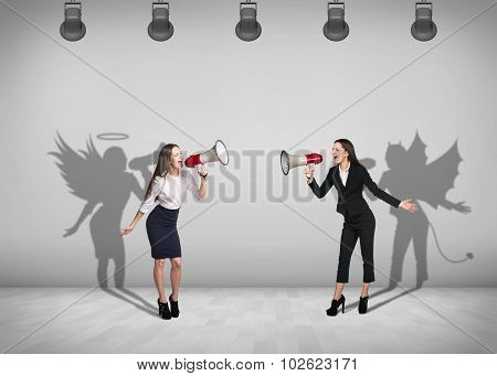 Businesswomen stands with shadow on the wall