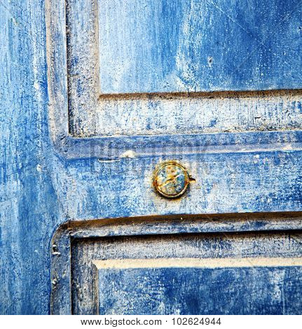Dirty Stripped Paint In The Blue Wood Door And Rusty Nail