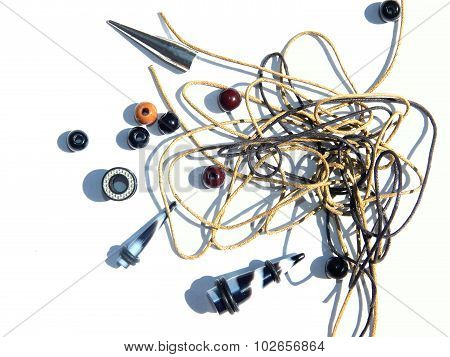 Abstract background with Piercing earrings, beads, ropes for bracelets