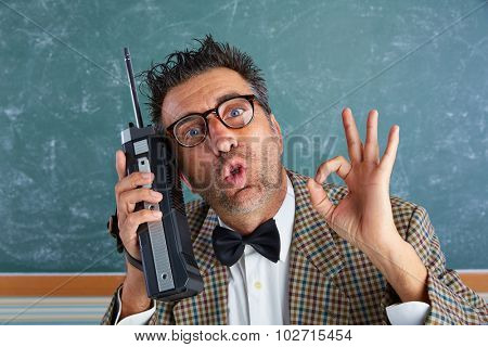 Nerd silly private investigator with retro walkie talkie on teacher blackboard