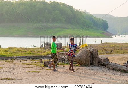 Unidentified young asian Mon boy enjoying with friends