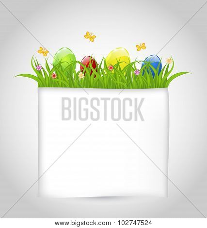 Easter colorful eggs in green grass with empty paper for your te