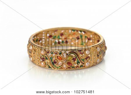Isolated Indian golden bracelet with intricate craftsmanship.