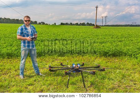 Man with multicopter on ground