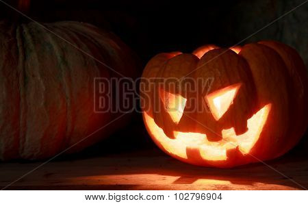 Selective Focus Bright Light In Pumpkins On Wood And Pumpkins Background By Dark Light Tone.
