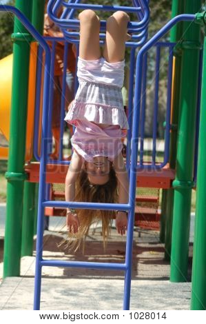 Upside-Down Girl On Monkey Bars