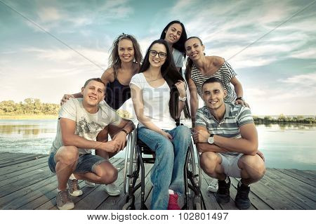 Happines group of Friedns on the wooden pier.