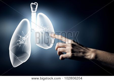 Close up of hand touching lungs sign