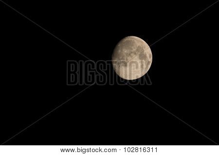 The photo shows the moon in the night in the starry sky