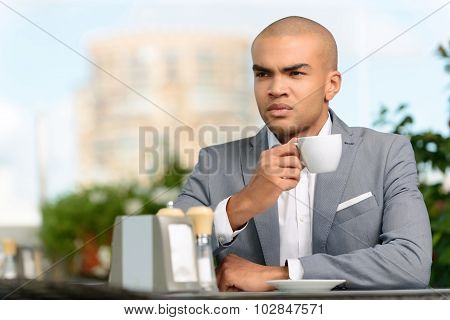 Pleasant businessman drinking coffee