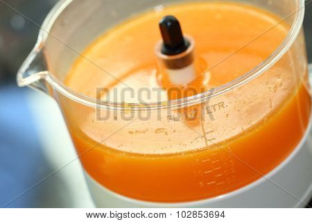 Fresh Orange Juice In Juicer Machine With Hand