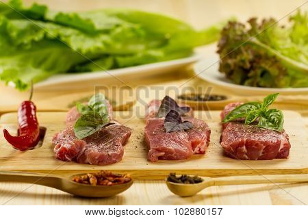 Fresh Raw Pork On Cutting Board With Spices And Herbs