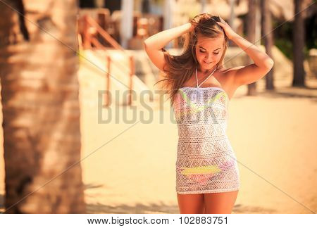 Portrait Of Blonde Girl In Lace Smiling Against Defocused Palms