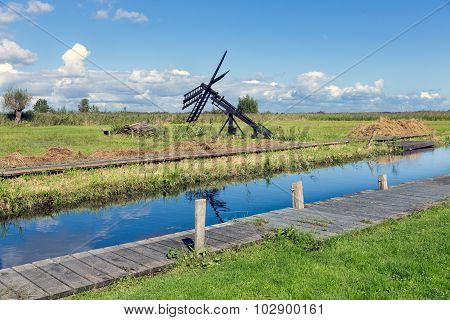 Dutch Landscape With Canal And Traditional Windmill