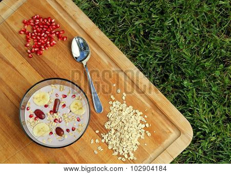 Oats and fruit cereal on grass.