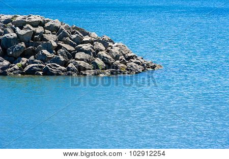 Edge Of Rocky Breakwall Ending In Water