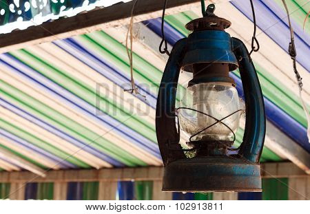 The Old Lamp Hangs On Beam Colorful Blur Background.