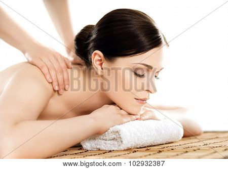 Young and healthy woman in spa salon. Traditional Swedish massage therapy and beauty treatments. 