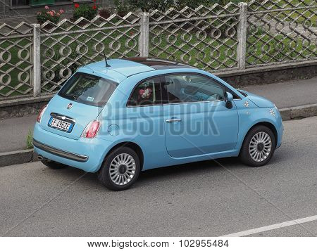 MILAN ITALY - CIRCA AUGUST 2015: light blue Fiat New 500 (2010s version) parked on a street