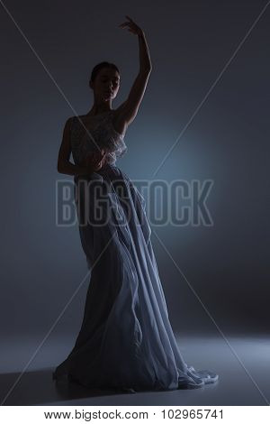 The beautiful ballerina dancing in blue long dress