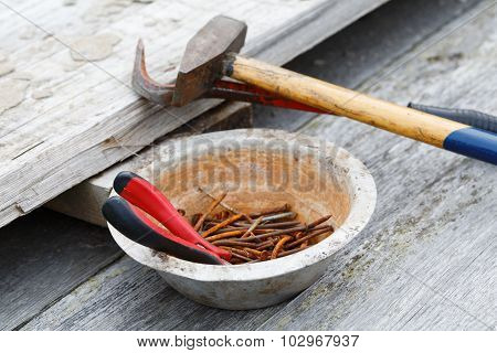 Claw Hammer And Rusty Nails On The Old Boards