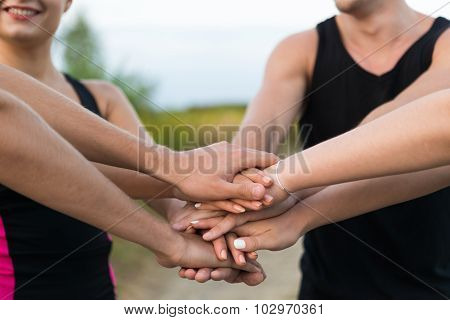Young People Putting Hands Together For Motivation