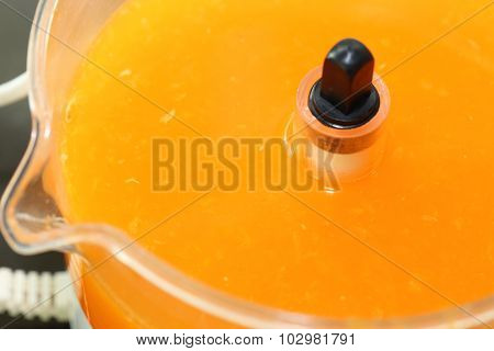 Fresh Orange Juice In Juicer Machine With Hand