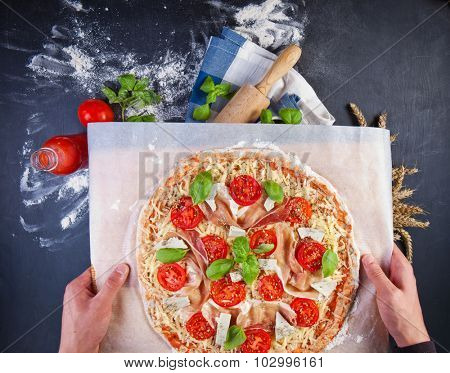 Closeup hand of baker making pizza at kitchen