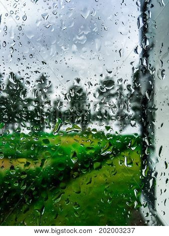 close up photo of rain drops in window.