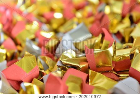 joss paper gold and silver paper for worship with Joss Paper Chinese Tradition. Gold Paper folded for passed away ancestor's spirits for chinese ceremony.