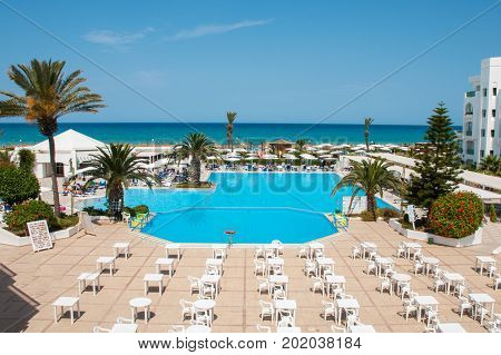 Territory of the hotel with a swimming pool a recreation area and the sea