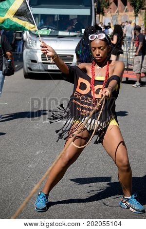 London United Kingdom - August 27 2017. Notting Hill Carnival one of the largest street parties in Europe is now in its 51st year. This year was close to the ruin of Grenfell Tower scene of a devastaing fire.