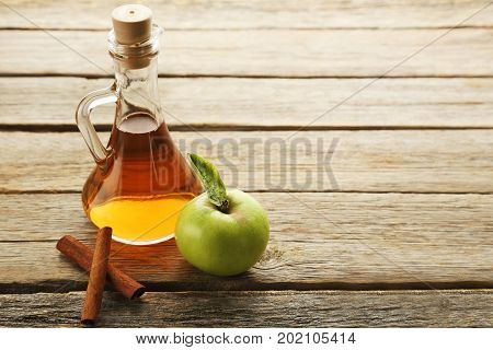 Apple Vinegar In Glass Bottle On Grey Wooden Table