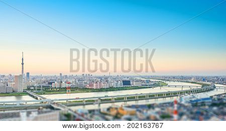 Business and culture concept - panoramic modern city skyline bird eye aerial view with tokyo skytree under dramatic sunset glow and beautiful cloudy sky in Tokyo Japan. Miniature Tilt-shift effect