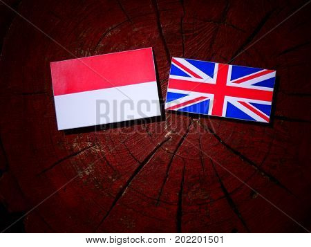 Indonesian Flag With British Flag On A Tree Stump Isolated
