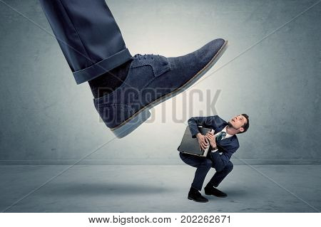 Demoralised employee symbolized by small man getting trampled