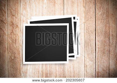 Blank photo frame on brown wood background. Top view with cop space for any design.Business and travel concept.