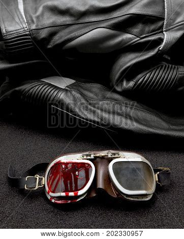 old Motorcycle glasses with blood and jacket behind