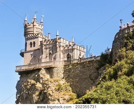 The castle is illuminated by the sun.
Small Castle Lastochkino Nest and its surroundings.