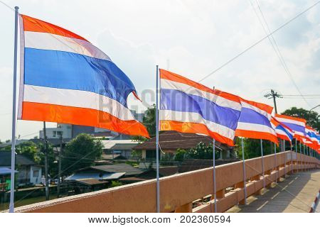 Close Up. Thai Flags On The Pole Blown By Wind At The Bridge.
