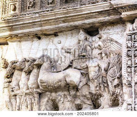 Titus Chariot Arch Roman Forum Rome Italy. Stone arch was erected in 81 AD in honor of Emperor Vespasian and his son Titus for conqueiring Jerusalem and destroying the Jewish temple in 70 AD. The Colosseum and the Arch were funded by the riches collected