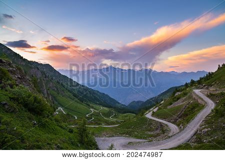 Dirt Mountain Road Leading To High Mountain Pass In Italy (colle Delle Finestre). Expasive View At S