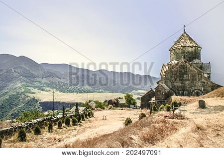 Back facade of the monastery Gregory the Illuminator against the backdrop of the mountains in the Armenian village of Haghpat