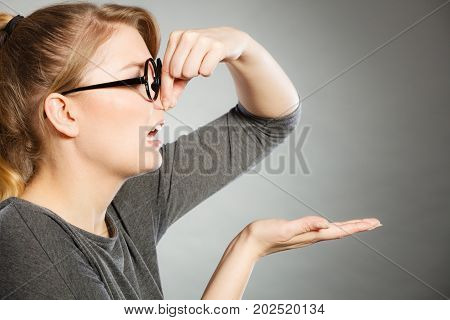 Girl Pinches Her Nose Because Of Stench Stink.