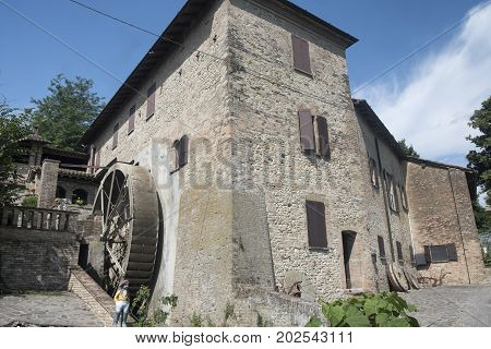 Country landscape at summer along the road from Fiorenzuola d'Arda to Castell'Arquato (Piacenza Emilia-Romagna Italy). Old farm house with watermill