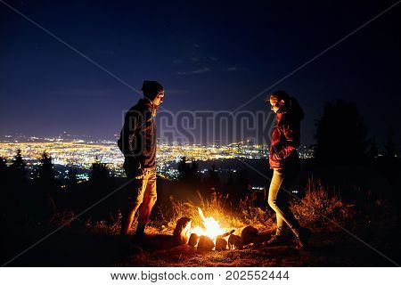 Romantic Couple Near Campfire At Starry Night
