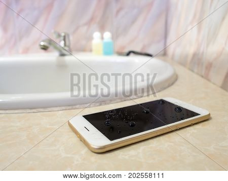 Water damage smart phone in wash basin. Water damage waterproof concept.