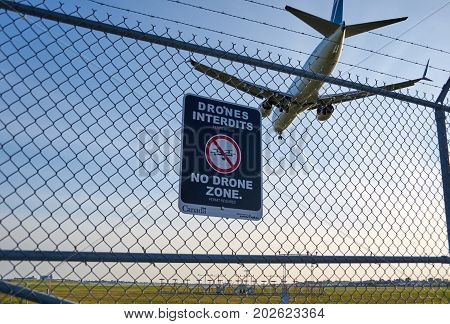 MONTREAL CANADA - AUGUST 28 2017 : No drones zone sign and airplane at Montreal YUL airport.